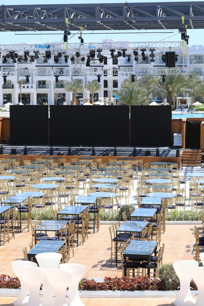 Outdoor event space with tables and stage setup