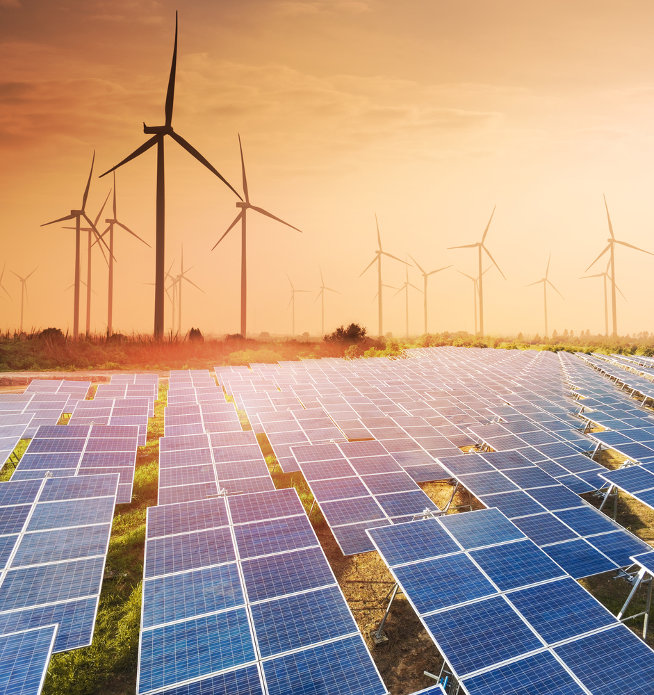 Renewable Energy Site Security by LVT Solar panels with wind turbines in the background, supported by LVT's renewable energy security solutions
